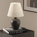 Table Lamp with Dark Ceramic Base and Light Linen Shade on Table with Book 3d model