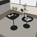 Black and white round coffee tables with magazines plants and cups in modern living room