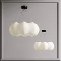 Two Cloud Shaped White Chandeliers With Black Base Against Gray Background