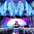Luxurious Banquet Hall Decor With Hanging Crystal Lights Flower Arrangements And Stage Screen