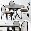 Round Dining Table with Woven Back Chairs Black Frame and Brown Seat Cushions
