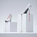 White High Heels Showcased On White Pedestals With Dripping Design Details