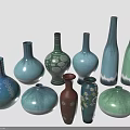 Assorted Colored Ceramic Vases In Different Shapes Holding Fresh Green Plants