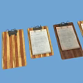 Three Wooden Clipboards With Metal Clips And Papers On Blue Background