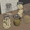 Clear Glass Spice Jars With Grains Beans And Pasta On Wooden Kitchen Countertop