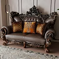Ornate Carved Leather Double Sofa With Orange Patterned Pillows On Wooden Floor And Patterned Rug