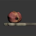 Gray Wooden Cutting Board With Two Fresh Ripe Pomegranates On Top
