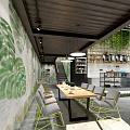 Modern Bubble Tea Shop Interior With Green Plant Wall Shelves Ingredients and Dessert Display Case