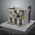 Detailed Model Building Featuring Yellow Walls Green Doors Windows Balcony Hanging Blue Cloth Ladder Structure