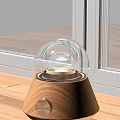 Illuminated Decorative Lamp With Transparent Glass Dome And Wooden Base On Window Sill