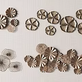 Metallic Flower Shaped Wall Decor Arranged On Neutral Toned Wall Surface 3d model