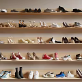 Various Styles Of Shoes Displayed On Wooden Shelves With Different Colors And Designs