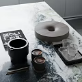 Stylish Decorative Ornaments Set With Black Mug Wooden Tray And Glass Cups On Marble Countertop