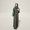 Woman Posing In Dark Abaya With Hijab And Light Blue Bag Against Light Background