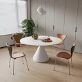Modern Round Dining Table Set with White Conical Base Four Brown Chairs and Green Plant