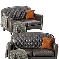 Dark Leather Double Sofa With Tufted Design Orange Pillow And Striped Blanket