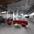 Modern Retail Space Interior With Red Sofa Chairs Small Tables And Clothes Racks