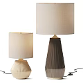 Two Stylish Table Lamps With Textured Bases And Beige Fabric Shades