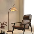 Indoor Scene With Rattan Backrest Chair Curved Pole Floor Lamp And Small Potted Plant