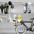 Pegboard Wall with Hanging Umbrellas Coats Scarves Skateboards and Bicycle Leaning Against