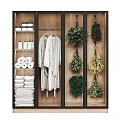 Bathroom Cabinet With Toilet Paper Rolls Towels Bathrobe And Green Plants