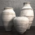 Handcrafted Ceramic Jars with Textured Surface Against Gray Wall and Wooden Floor