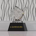 Three Golden Silver and Crystal Trophies with Black Bases and Engraved Team Recognition Text
