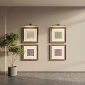 Framed Abstract Paintings On Wall With Green Plant In Bright Interior