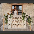 Decorative Balcony Structure With Arch Patterns And Potted Flowers By Brick Window