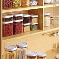 Wooden Kitchen Cabinets Featuring Glass Jars With White Lids For Grains Storage