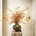 Stylish Vase With Orange And Green Decorative Flowers On Wooden Stump In Light Room