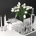 Silver Wine Bottle And Clear Glasses On Stylish Table With White Tulips Candles And Books