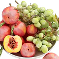 Fresh Ripe Peaches and Green Grapes in White Bowl with Juicy Flesh and Leaves