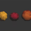 Three Vibrant Cocoa Pods in Yellow Red and Orange Tones on Reflective Black Background