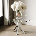 Modern Glass Top Side Table With Metal Cross Base And White Flower Vase