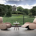 Beige Massage Chairs With Wooden Floor And Small Round Table By Scenic Garden View