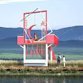Red Observation Deck With LOVE Signage Mountain Waterfront Grassland View