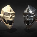 Two Beige And Silver Skull Hats With Mesh Face Mask And Side Tube Design
