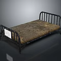 Vintage Metal Bed Frame Featuring Worn Brown Mattress And Black Metal Rails