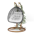 Stylish Rattan Hanging Chair With Gray Padded Cushion Wooden Stand And Green Vines