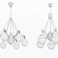 Lighted Modern Golden And Silver Chandeliers With Spherical Glass Shades Hanging From Ceiling