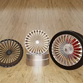 Stylish Three Automotive Wheel Rims and Tire Black Silver Red Accent on Wooden Floor