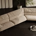 Beige Modern Sectional Sofa Upholstered With Metal Legs Potted Plant And Cat On Cushion