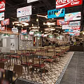 Vibrant Restaurant Interior With Hanging Coca-Cola Signs HiPPO Banners And Tables Chairs
