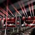 Elegant Banquet Hall Setup With Long Dining Tables Black Chairs And Red Stage Lighting