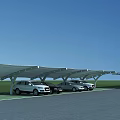 Outdoor Carport Canopy with Parked Cars Under Blue Sky and Green Lawn