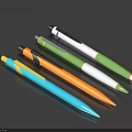 Vibrant Colored Ballpoint Pens in Blue Orange Green White on Dark Background