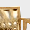 Modern Wooden Armchair With Grey Cushion And Blanket On Armrest