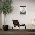Leisure Chair in Interior with Large Green Plant Black Pot Abstract Wall Art Wooden Table and Vases