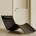 Black Modern Curved Lounge Chair In Minimalist Interior With White Door And Light Wall